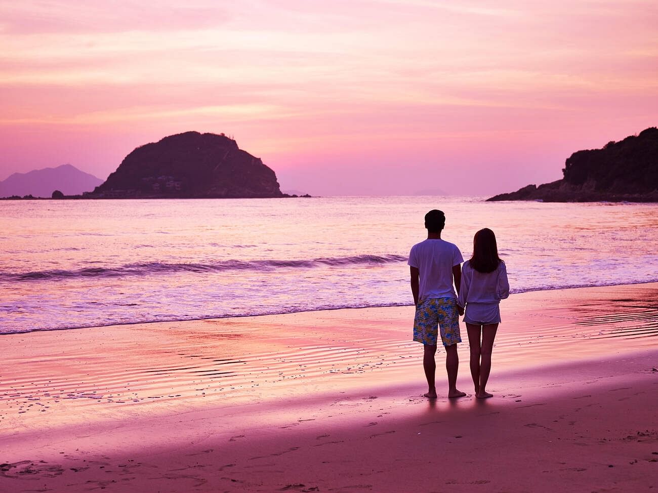 couple-taking-a-walk-on-beautiful-beach