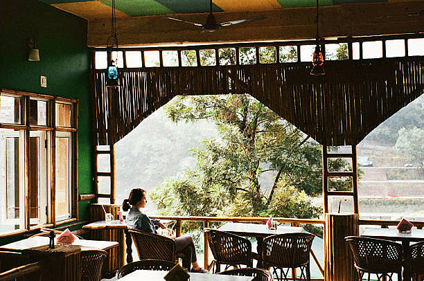 Woman sitting on balcony of cafe