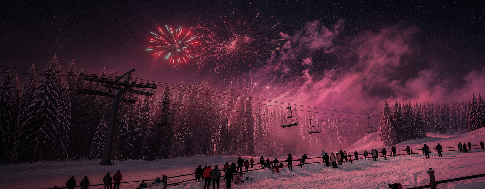 Fireworks over a snow-covered ski resort on New Year's Eve