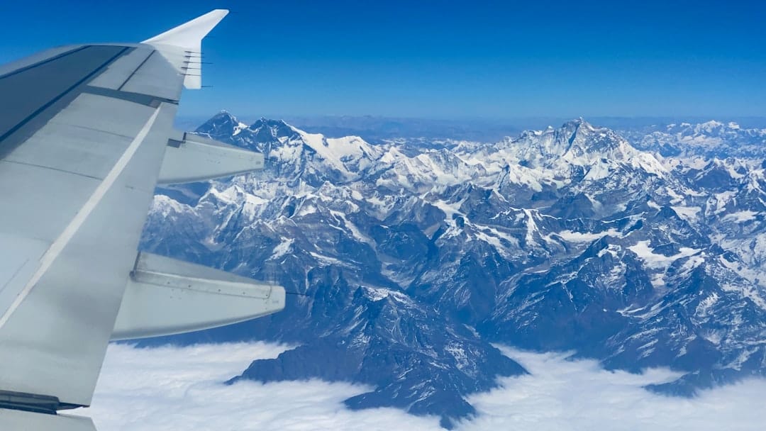 Flying to Leh offers stunning aerial views but requires careful acclimatization upon arrival. - Photo by Mike Swigunski on Unsplash